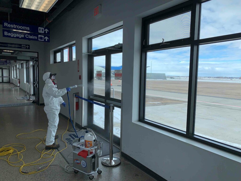 Man sanitizing the doors