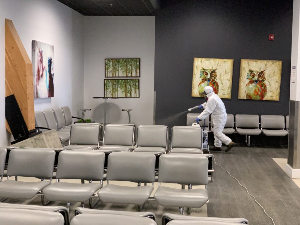 Man sanitizing the waiting area chairs