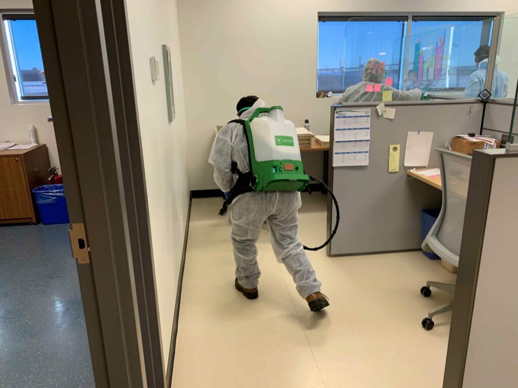 People sanitizing the office