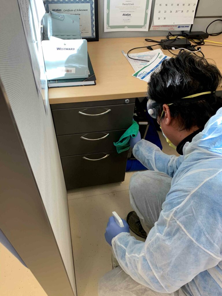 Man wiping the cabinet