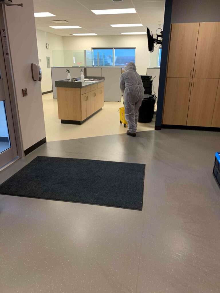 Man in PPE suit cleaning