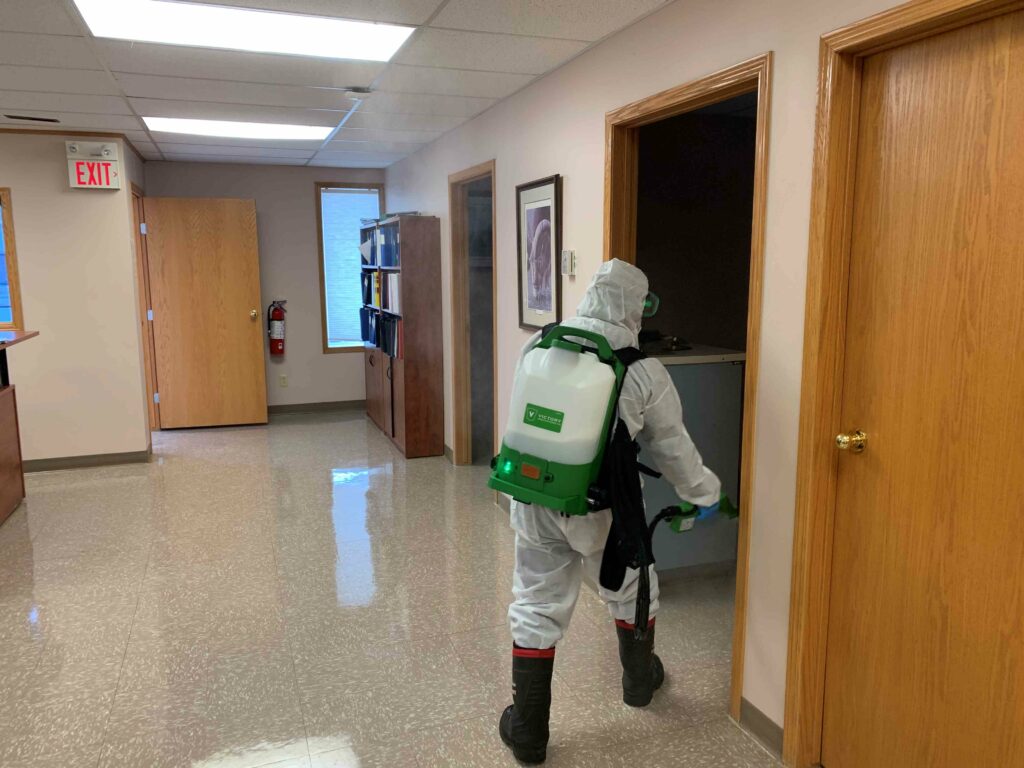 Man sanitizing the rooms