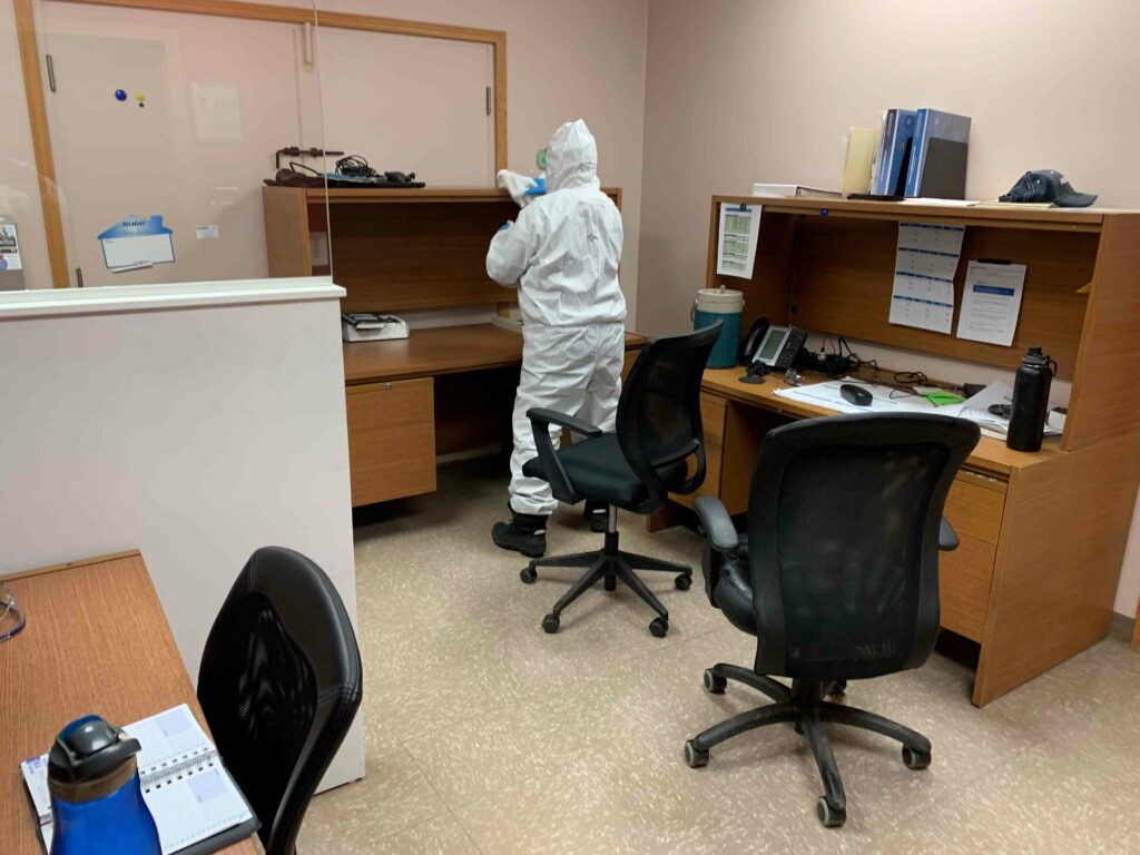Man cleaning the office desks