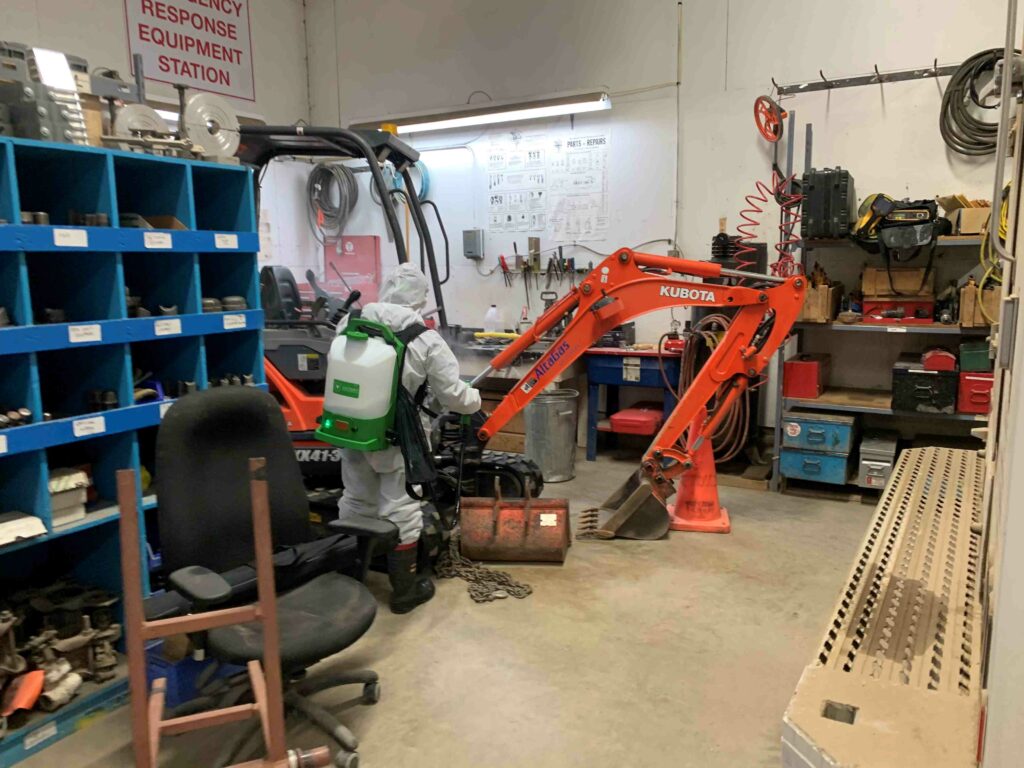 Man sanitizing the equipments