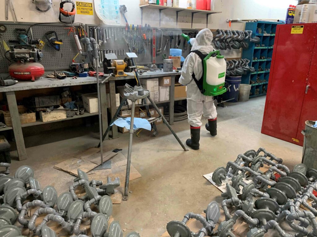 Man sanitizing the bench area tools