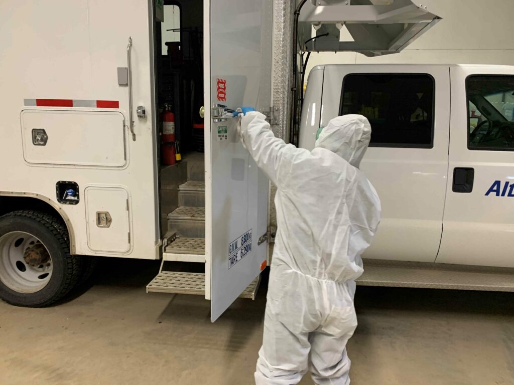 Man sanitizing a truck van