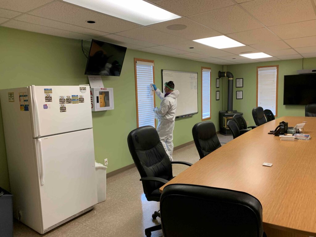 Man cleaning the window blinds